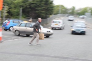Pedestrian taking unnecessary chance to cross busy street mid-block